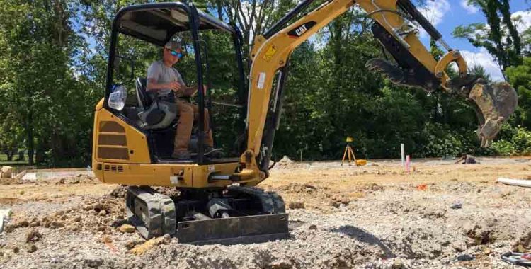 A skilled professional maneuvering a heavy equipment used in digging out dirt